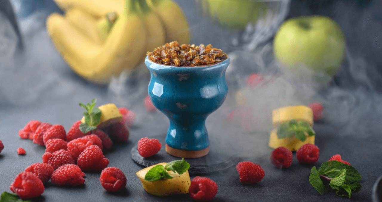 hookah bowl full of flavour with some fruits arround