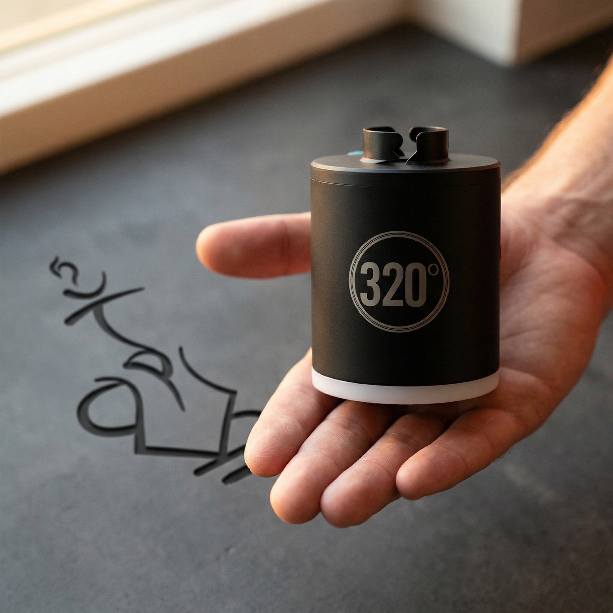 320° LED electric shisha starter pump held in an open hand showing its compact palm-sized form factor — a portable hookah starter you can take anywhere.