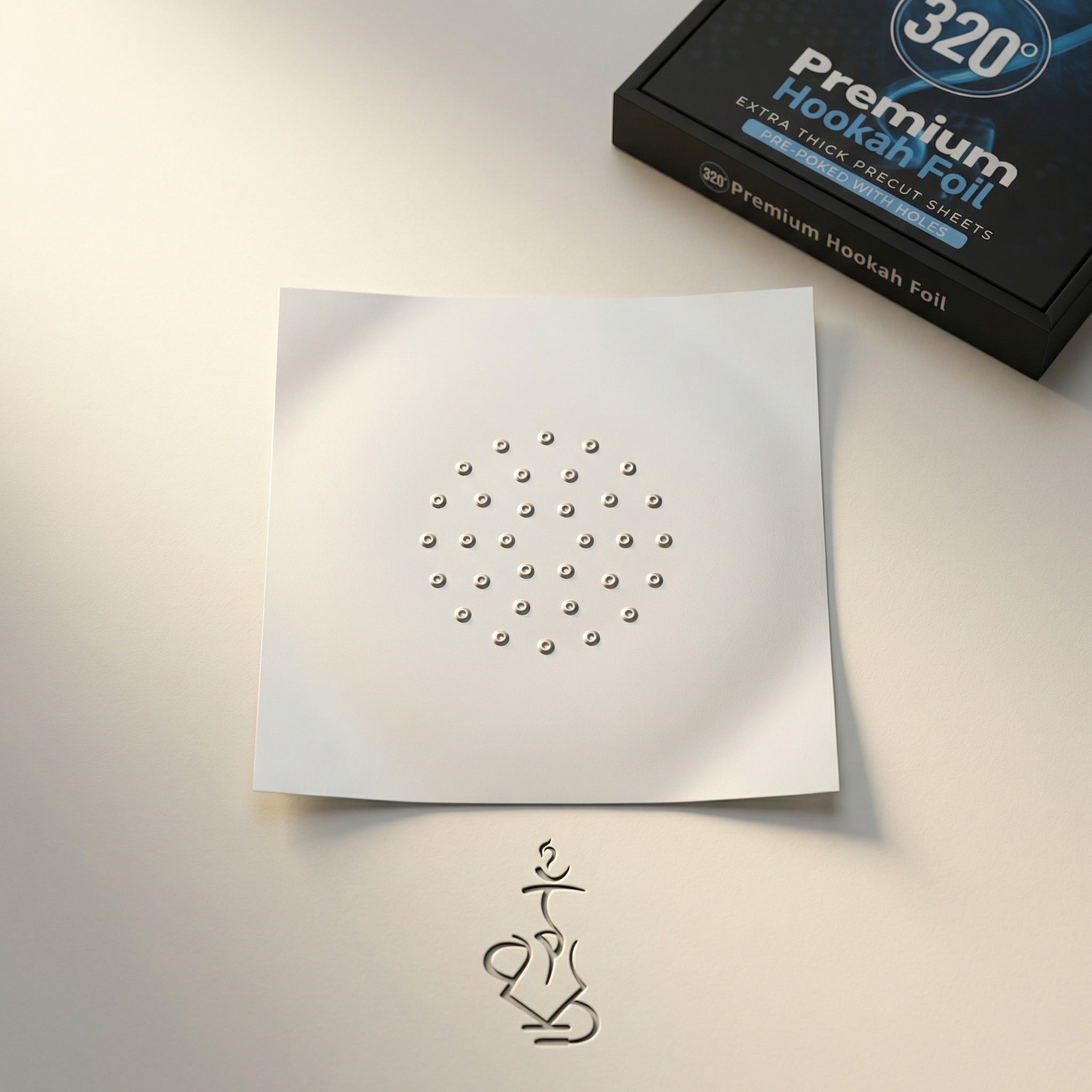 320° Premium Hookah Foil open box alongside a fanned stack of pre-poked shisha foil sheets on a warm dark concrete prep surface, editorial magazine-spread style.