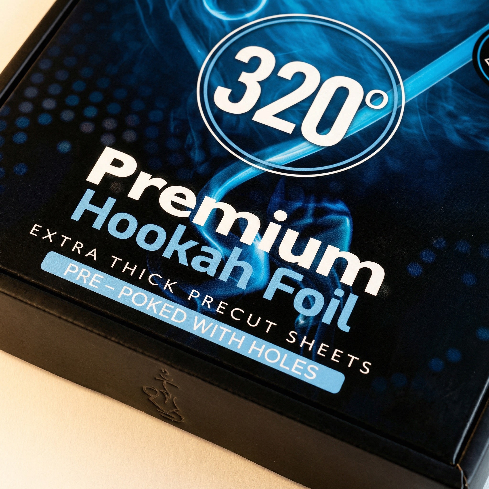 Single square 320° pre-poked hookah foil sheet on a warm white surface, showing the distinctive diamond cluster of pre-poked airflow holes on the matt side.