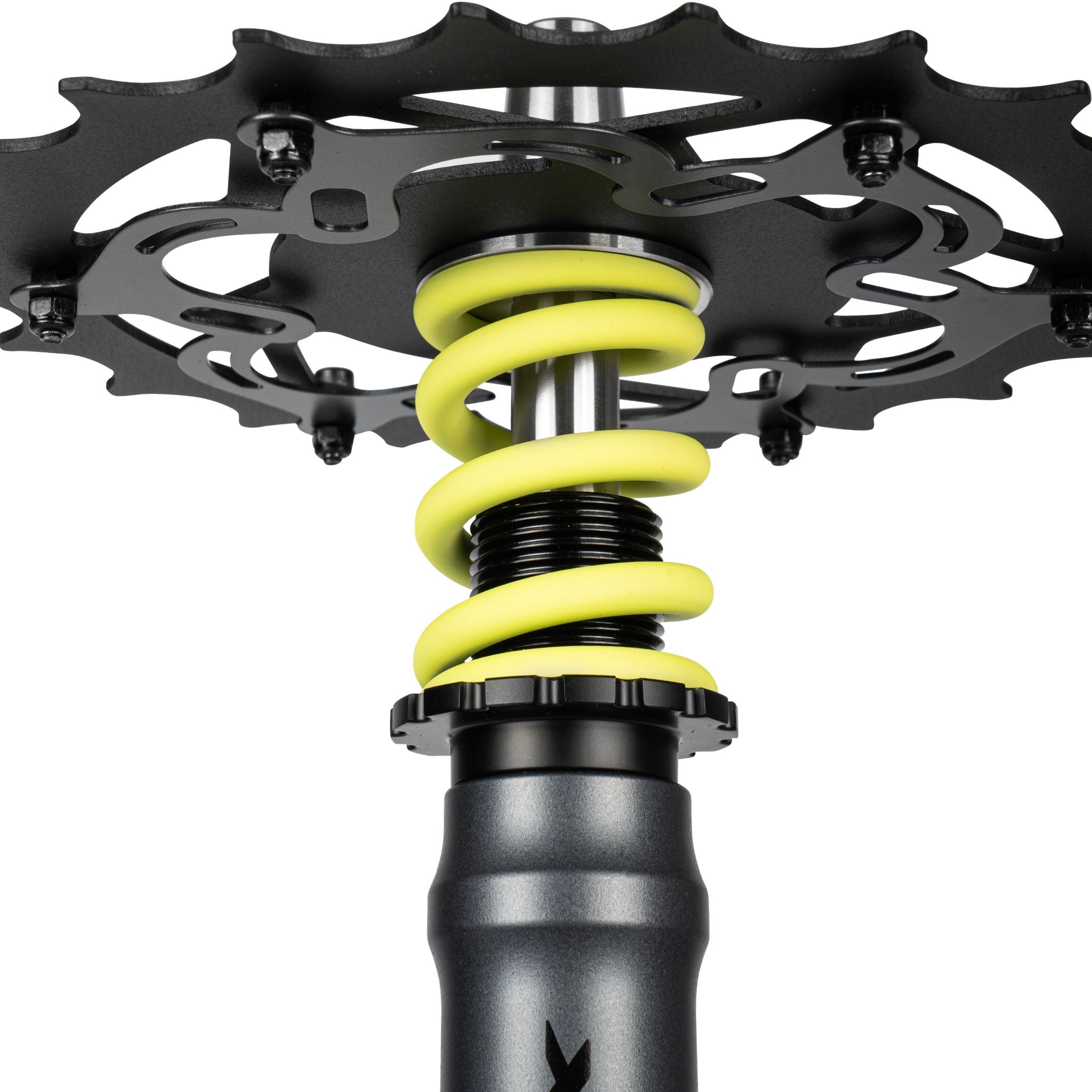 Amotion Pedal RX Slate chainring underside close-up — slate-grey bike-style cog over the yellow coil spring and stem