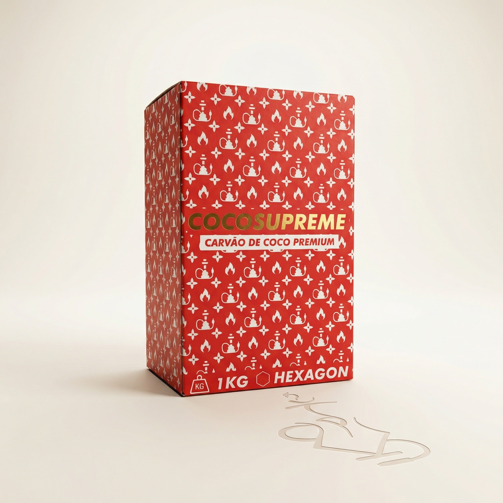 Cocosupreme Hexagon 1kg coconut charcoal box in bold red with white hookah monogram pattern and gold branding on a warm white studio background.