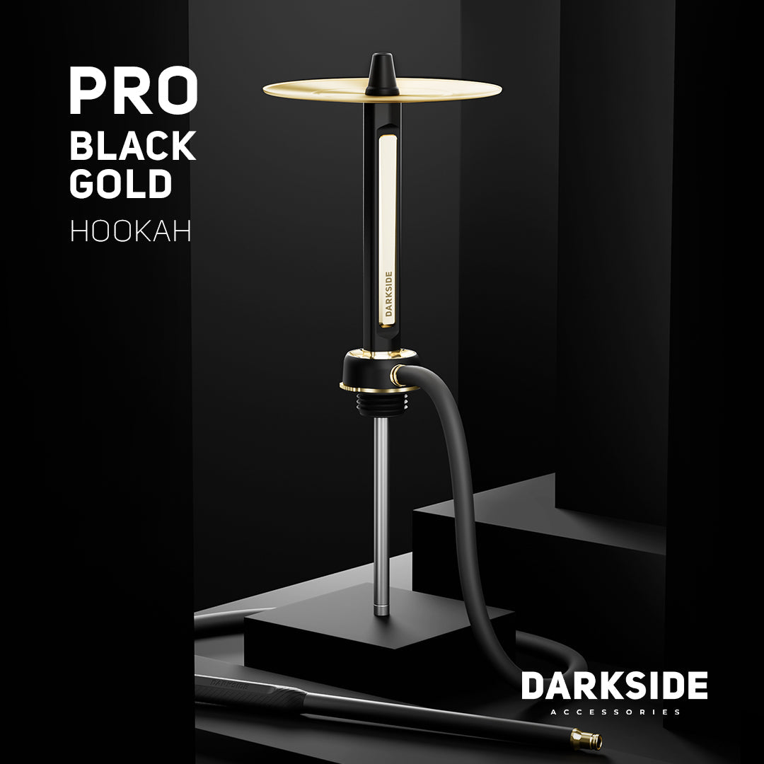 Darkside Pro Black Gold shisha on a dark podium with its hose coiled at the base
