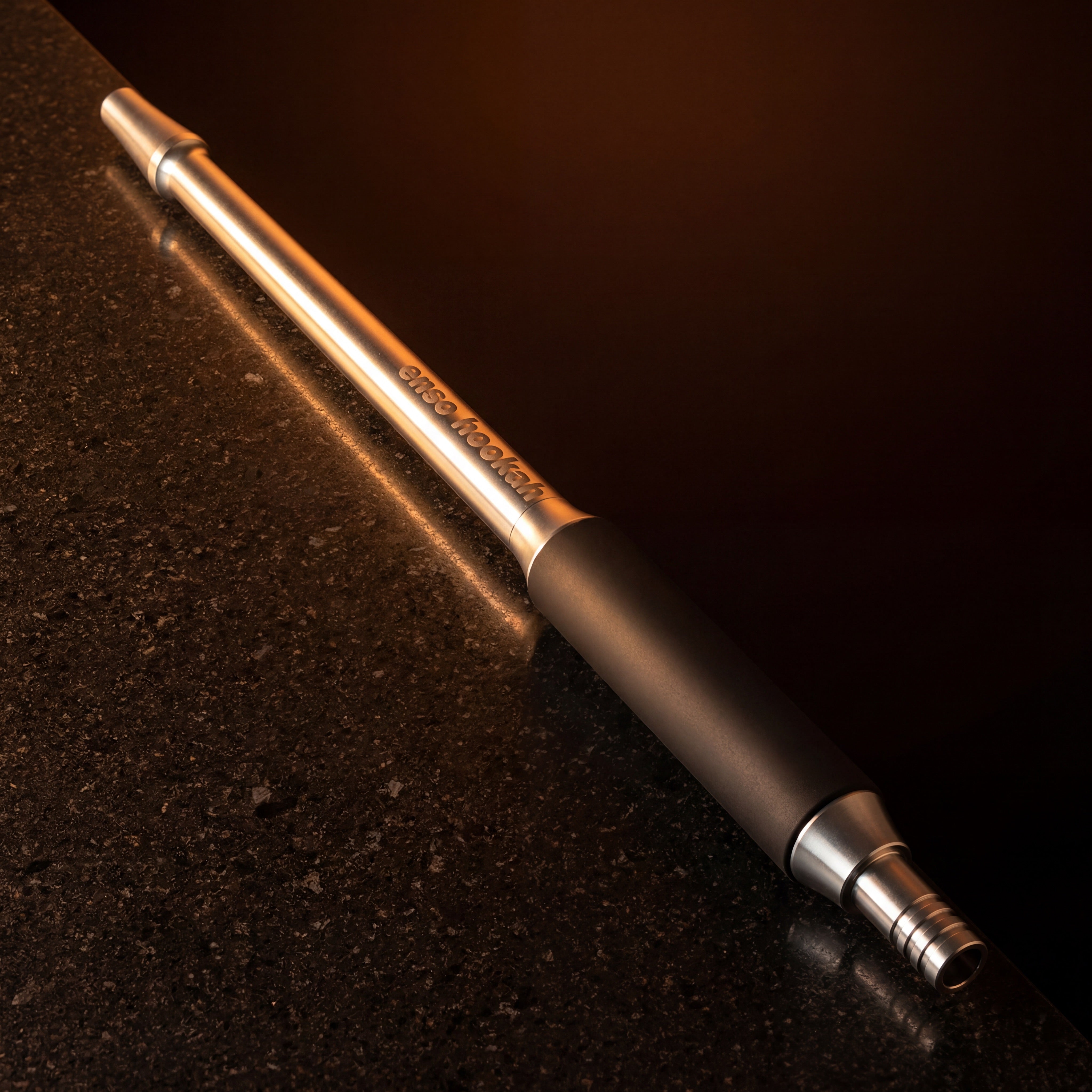 Enso Hookah Modular Mouthpiece lit by warm amber glow on a dark stone surface – The Premium Way