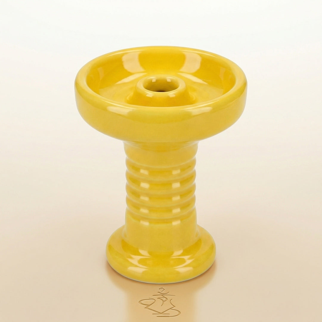 Essentials Glazed Phunnel Bowl in bright yellow, handmade clay with glossy glaze, showing the wide rim, concave basin, raised central spire, and ribbed stem in a clean studio setting.