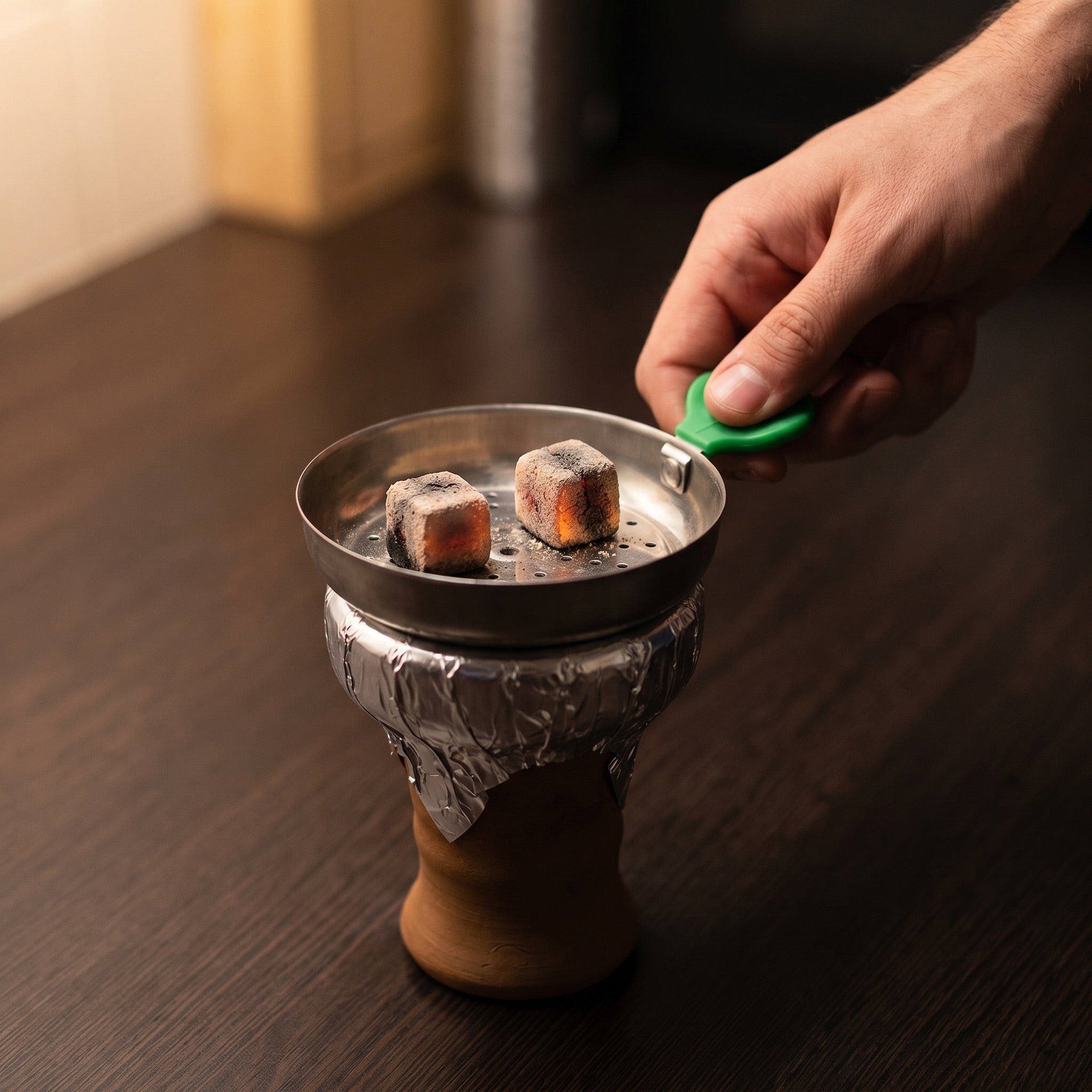 Essentials Leaf Heat Management Screen in use on a shisha bowl with lit natural charcoal cubes from The Premium Way
