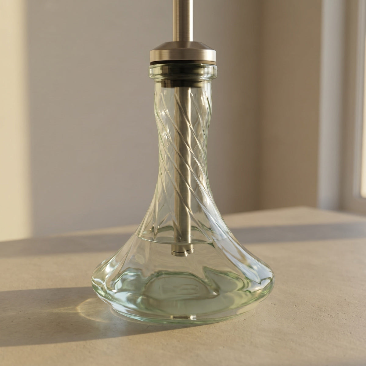 Essentials Twist Clear shisha vase paired on a brushed steel stem in golden hour daylight, spiral magnified through the glass body, image 3 of 5