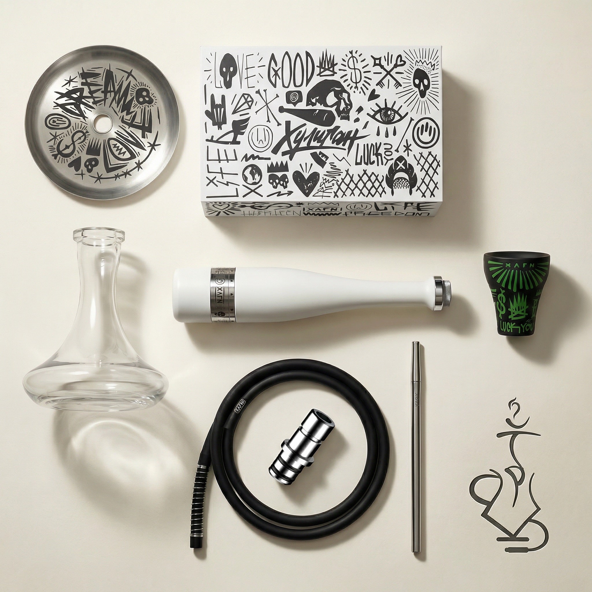 Hooligan White Baseball Bat Hookah complete set flat lay showing the stem, glass base, ash plate, graffiti bowl, silicone hose, chrome mouthpiece and adapter laid out on warm white studio paper.
