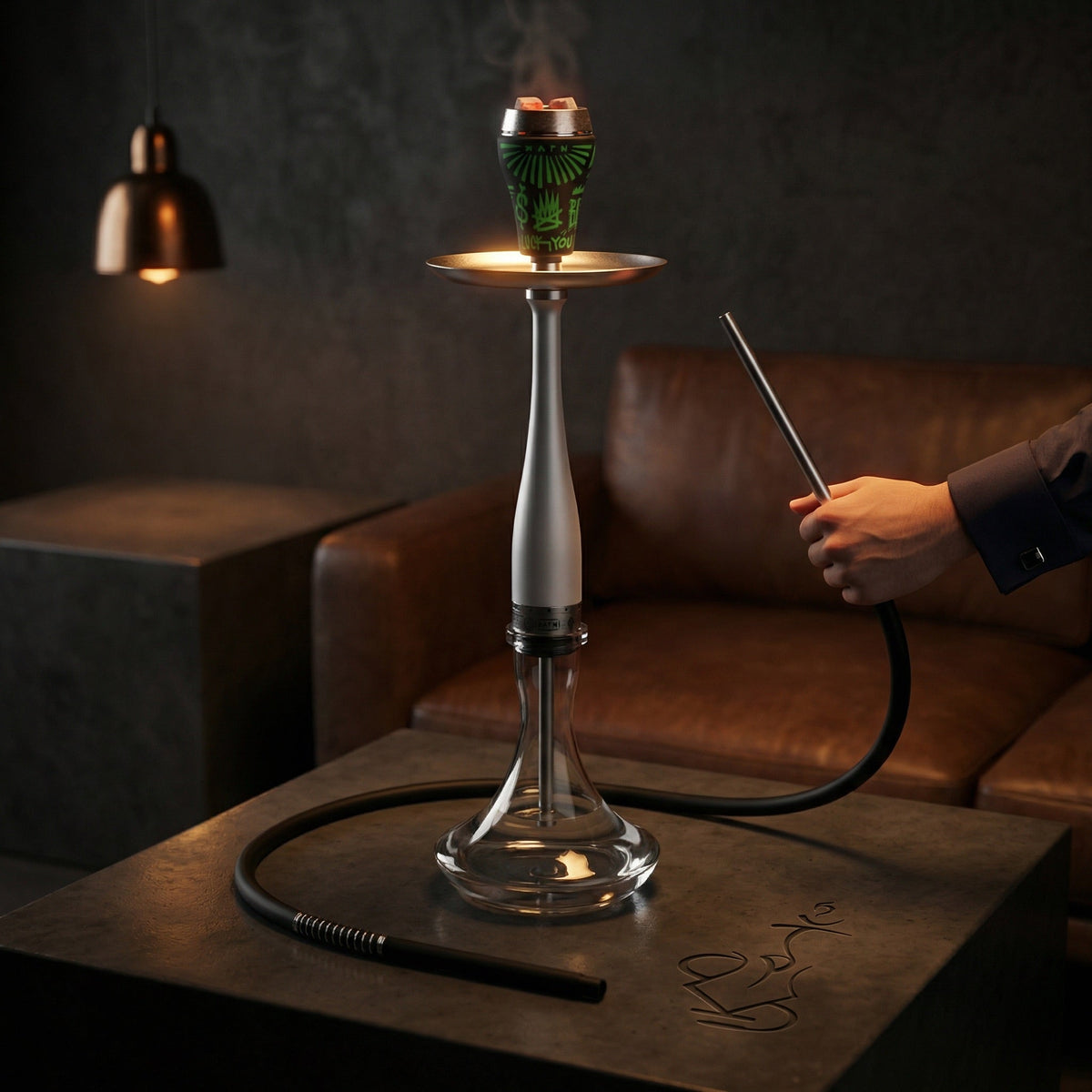 Hooligan White Baseball Bat Hookah set up in a moody premium lounge with a hand gripping the chrome hose handle, full session-ready assembly with bowl and hose connected., image 2 of 25