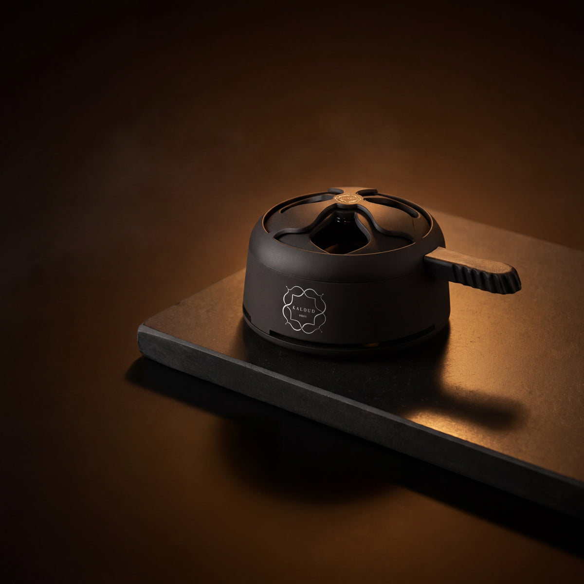 Matte black Kaloud Lotus I+ Niris HMD on a dark stone slab under warm amber lighting., image 5 of 15