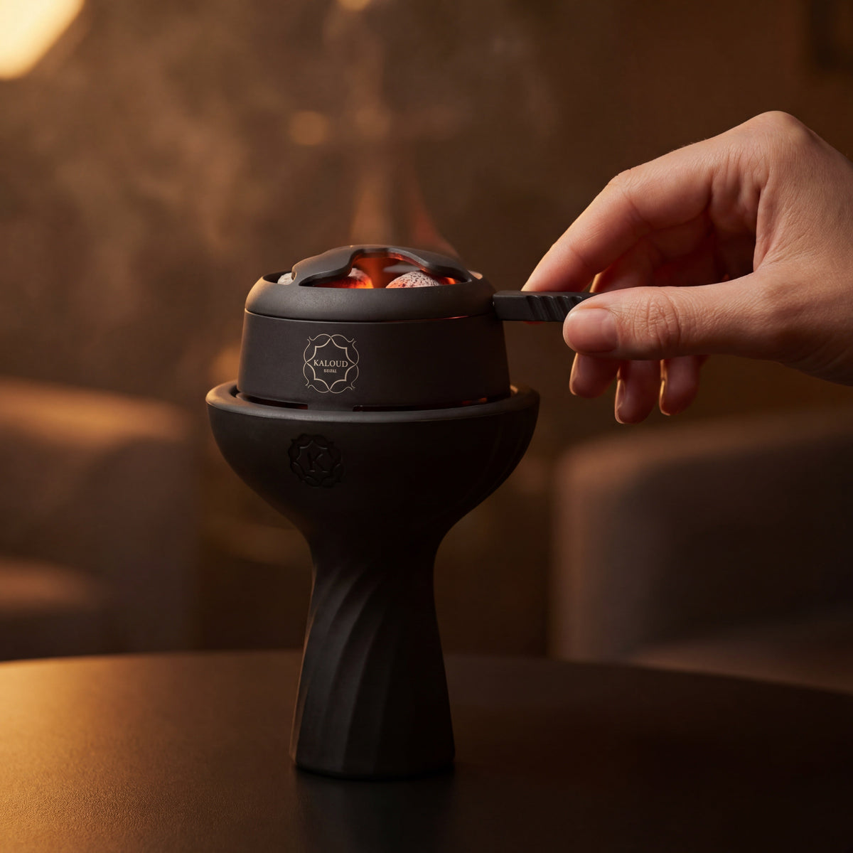 Hand adjusting the airflow lever on a Kaloud Lotus I+ Niris during a live session with glowing coals., image 10 of 15