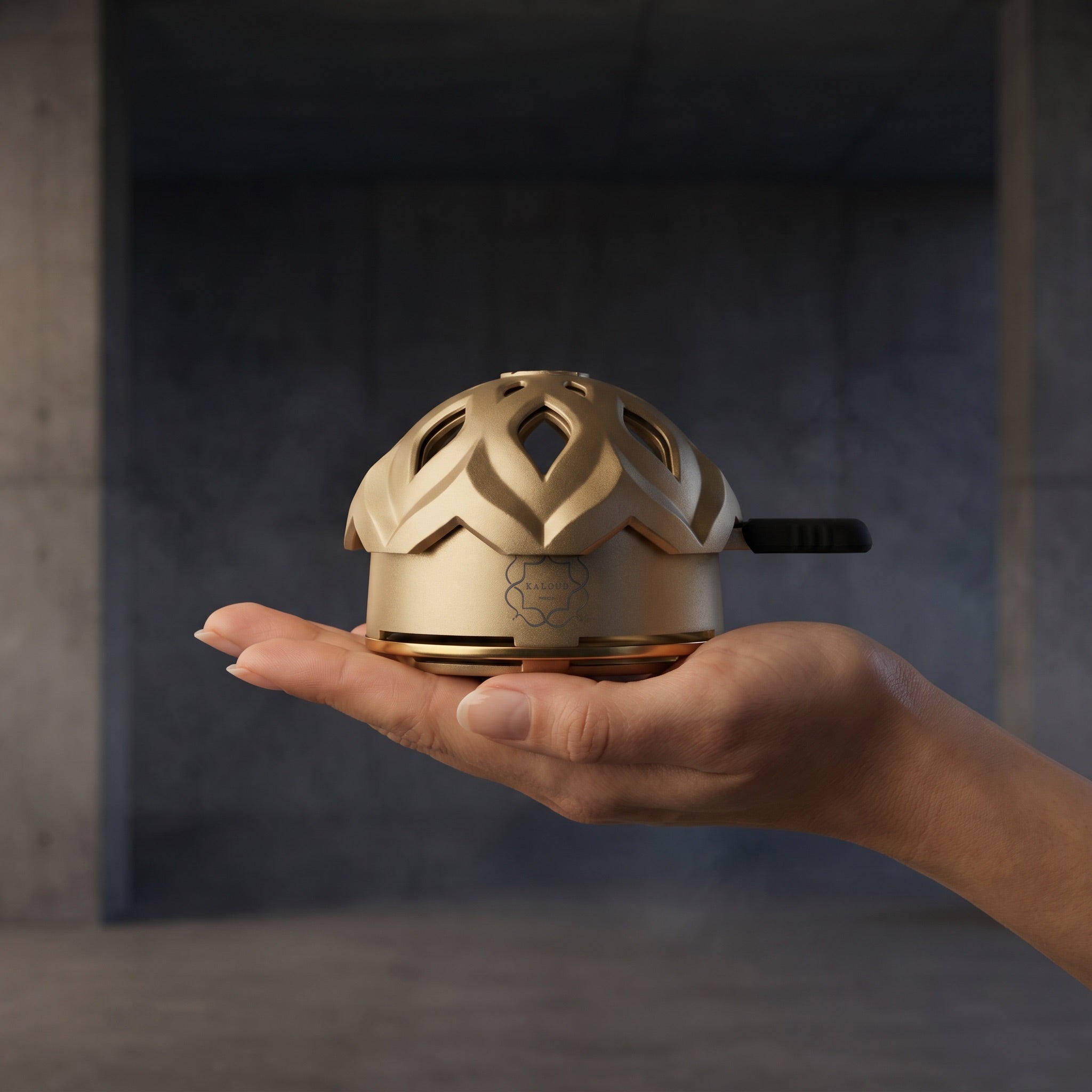 Kaloud Lotus I+3 Auris Gold HMD cradled in open palm, scale and compact size shown