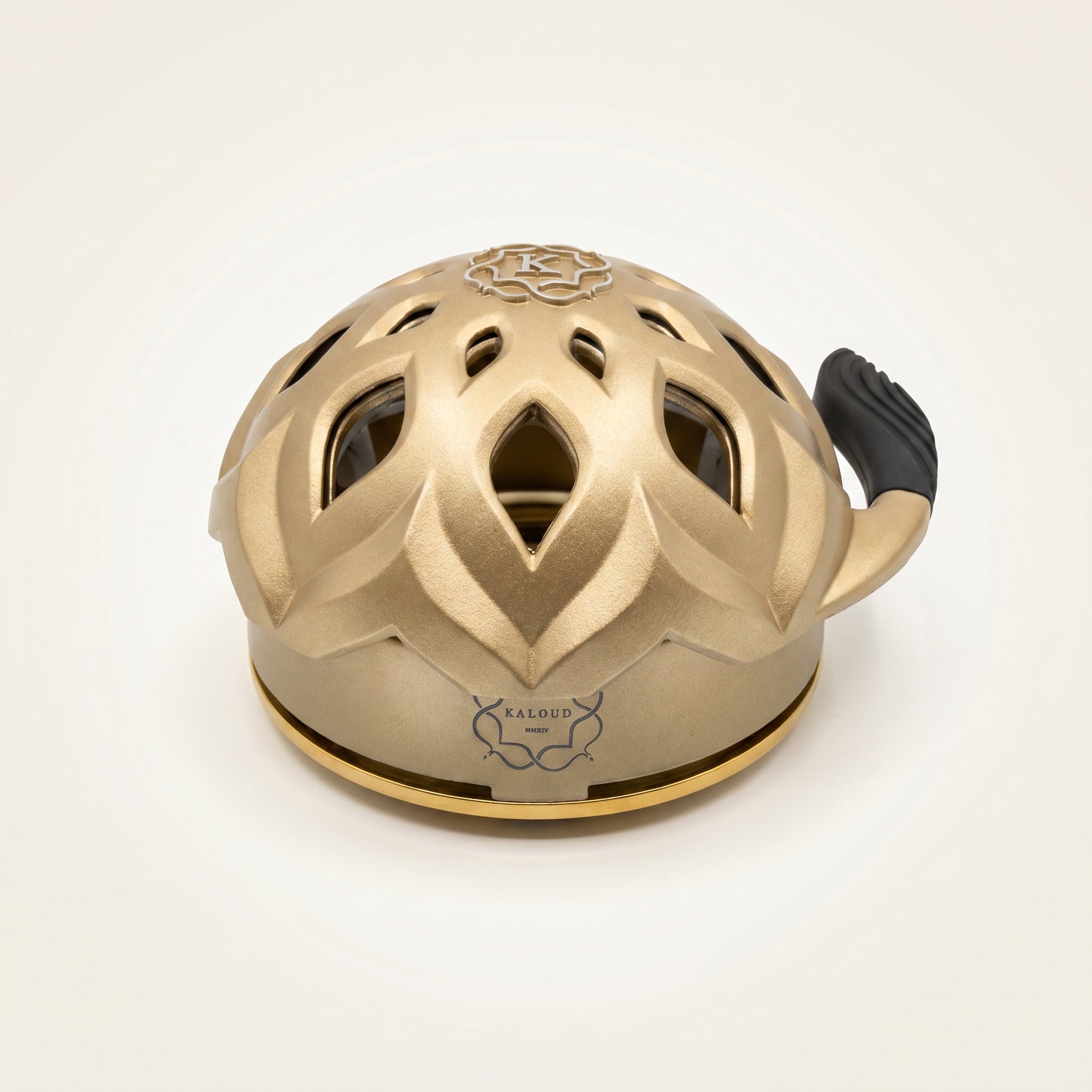 Kaloud Lotus I+3 Auris Gold heat management device, three-quarter studio view on near-white sweep