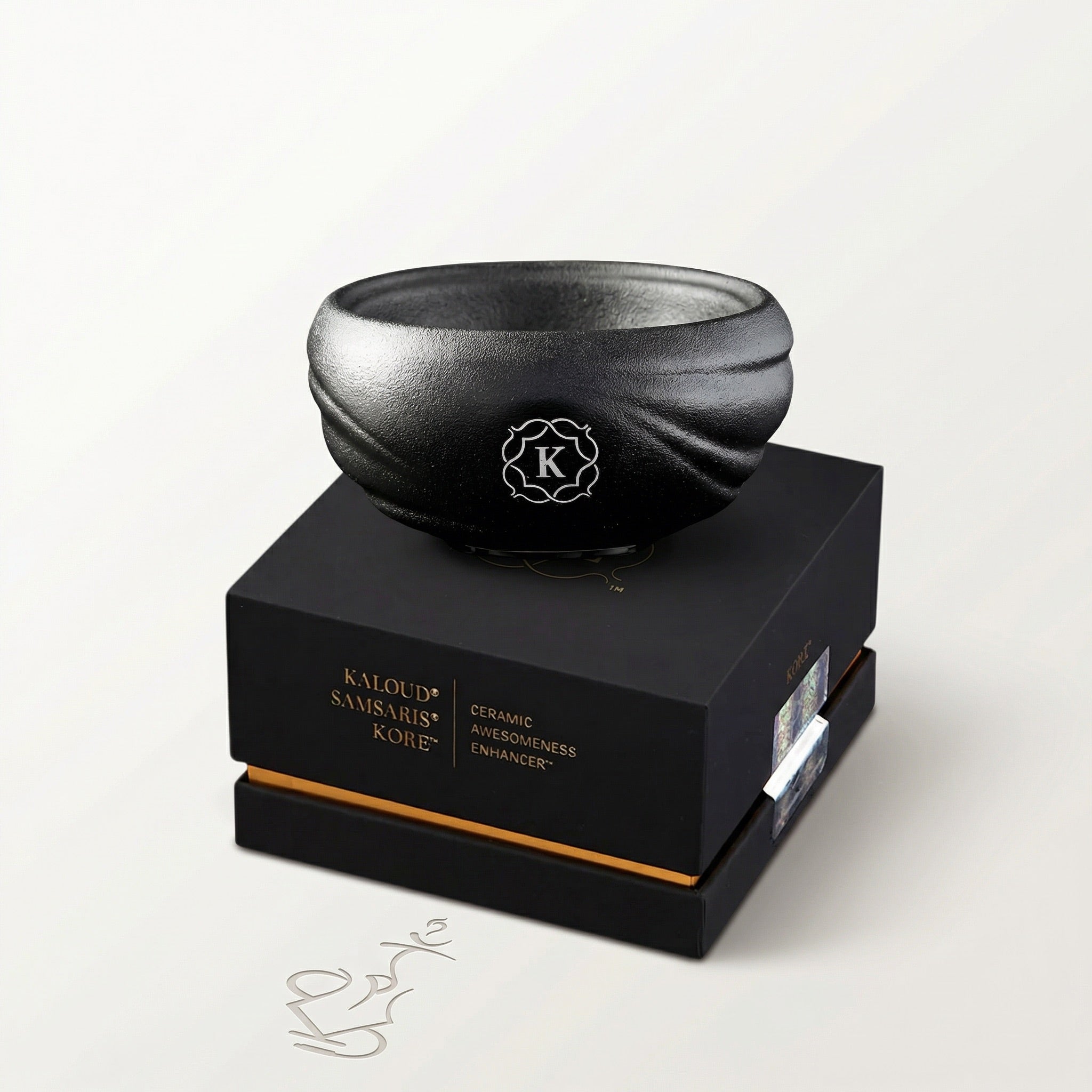 Kaloud Samsaris Kore All Ceramic shisha bowl resting on premium black-and-gold Kaloud presentation box on a warm white studio background