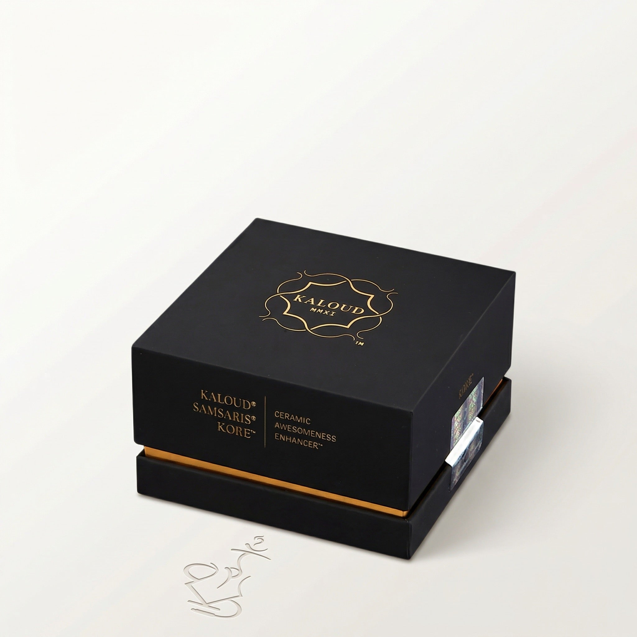 Premium matte black Kaloud Samsaris Kore presentation box with gold foil crest and holographic RFID security sticker