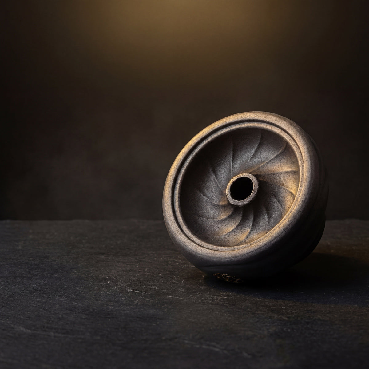 Kaloud Kore Dào Short black clay phunnel bowl on dark slate with warm gold backlight, swirl detail visible, image 3 of 12