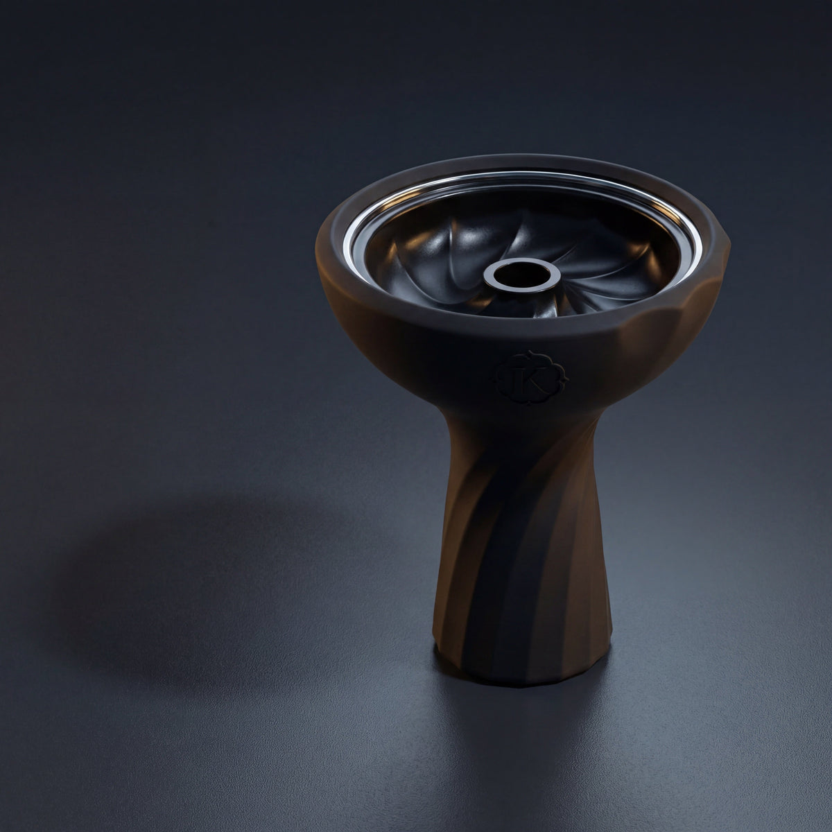 Kaloud Samsaris Lapis II ceramic shisha bowl on polished slate in dim modern interior with warm directional light catching the chrome ring, image 2 of 13