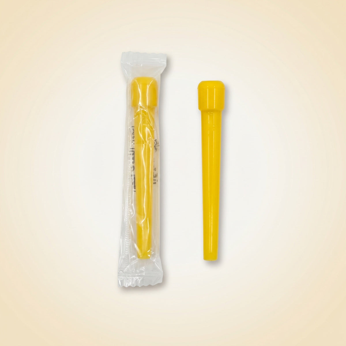 Single Khalil Mamoon disposable shisha tip shown sealed in its individual wrapper beside an unwrapped yellow tip, image 4 of 10