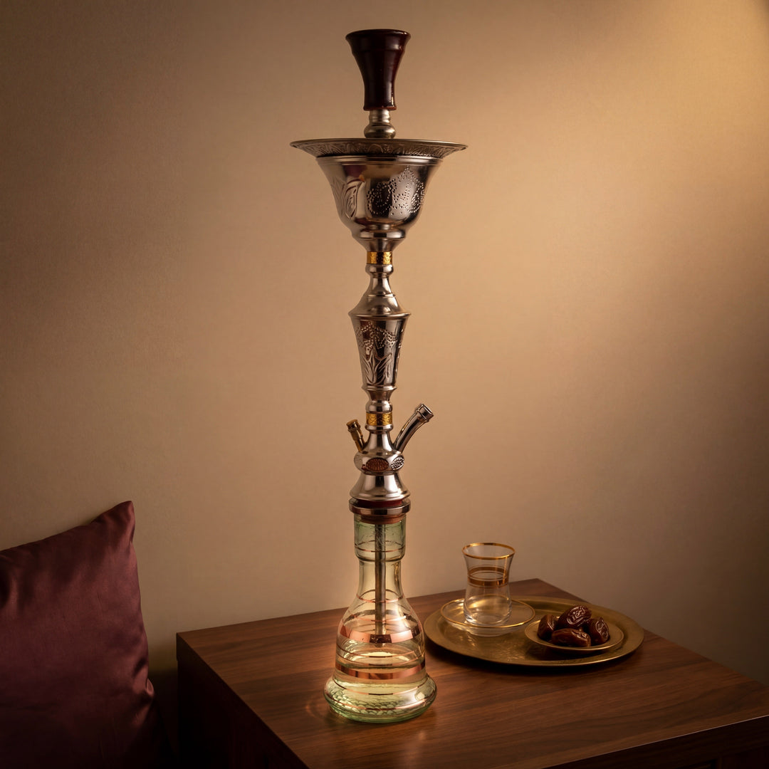 Khalil Mamoon Ice Lotus 1511 polished silver hookah on walnut table in warm majlis evening corner