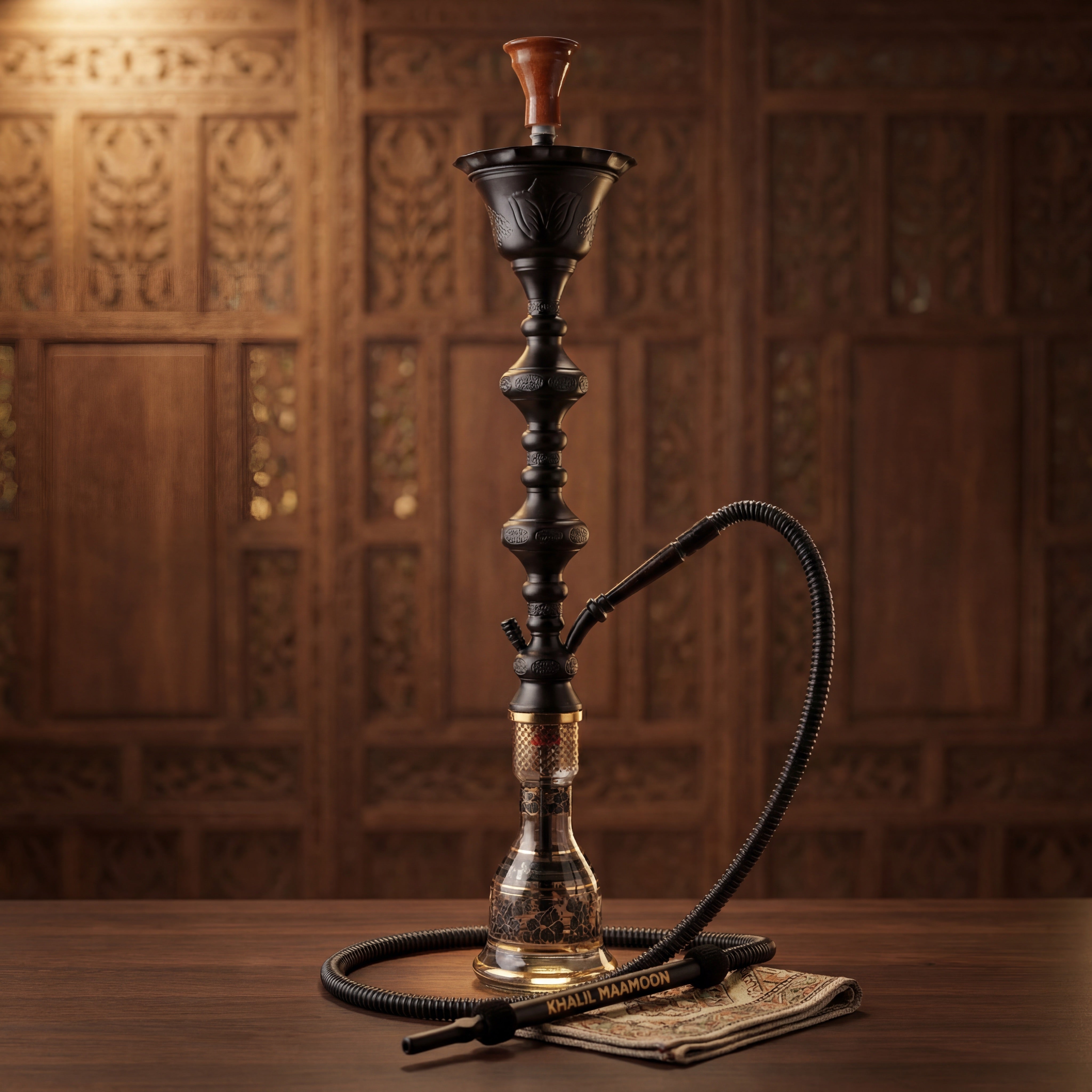 Khalil Mamoon Ice Shareef Black 90cm hookah with attached hose and KHALIL MAAMOON wand mouthpiece on dark walnut