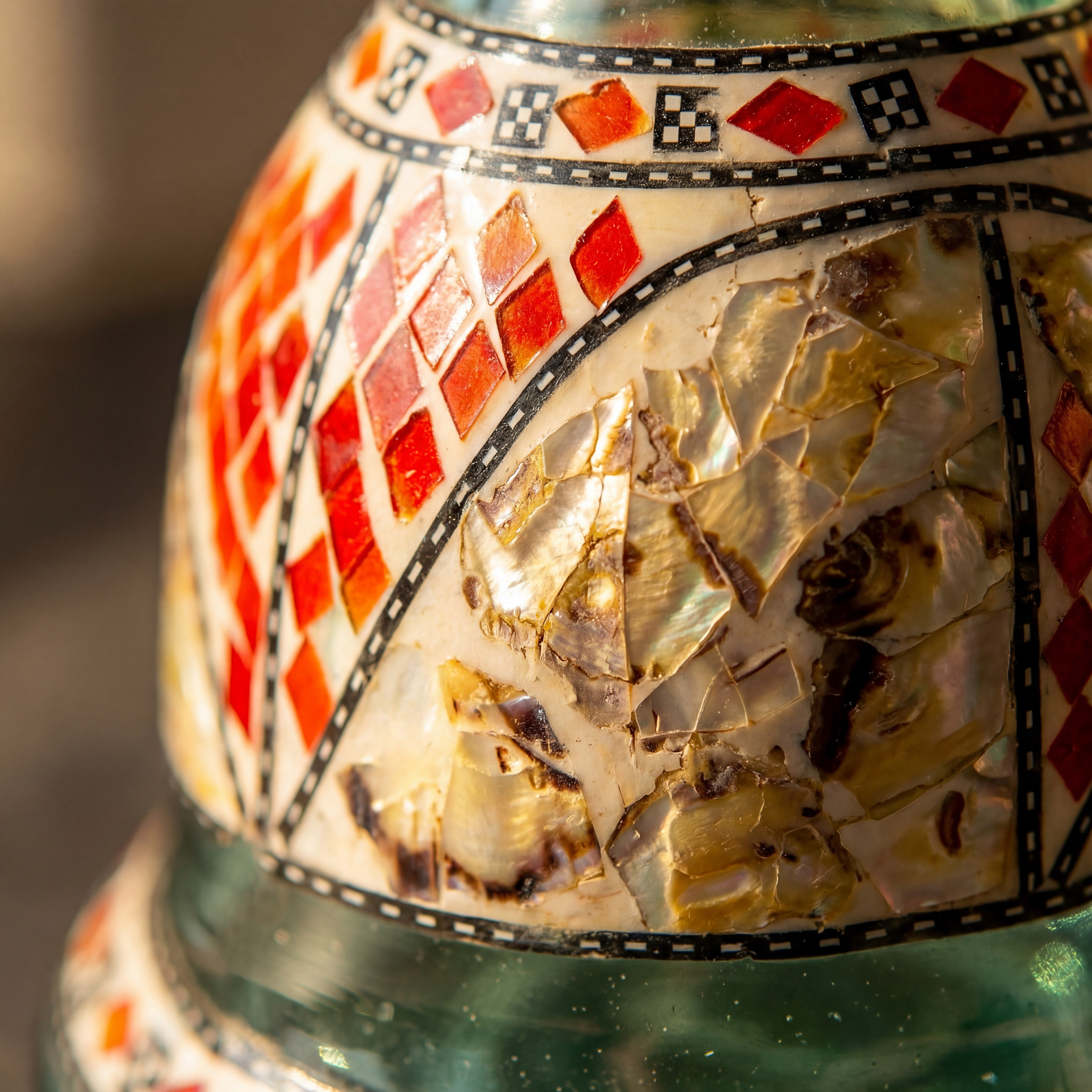Macro of Khalil Mamoon Sadaf base showing hand-set red enamel diamonds and shell inlay, The Premium Way
