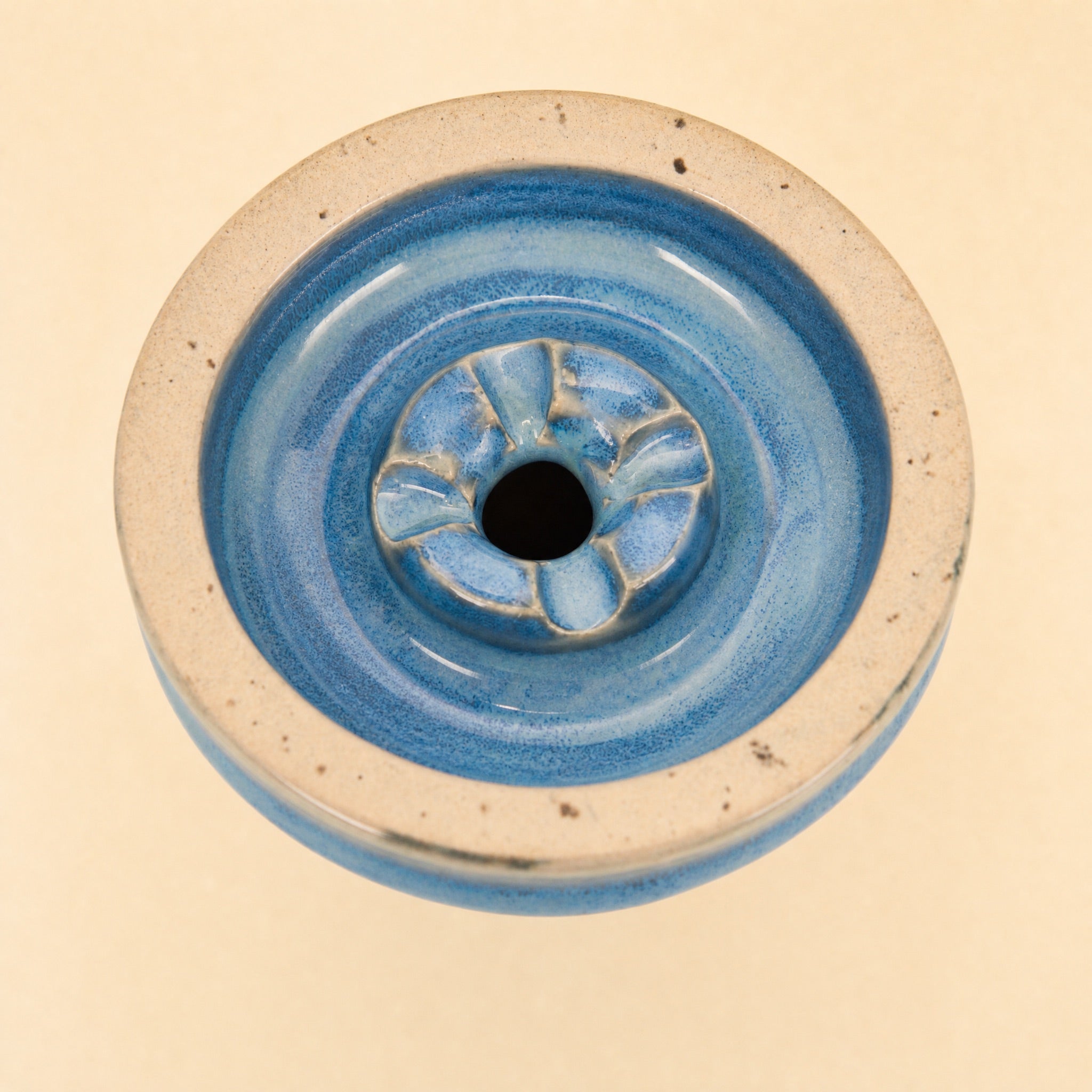MIT Luxury Ashera Tide bowl macro top-down detail of azure-blue mottled glaze around the phunnel spire
