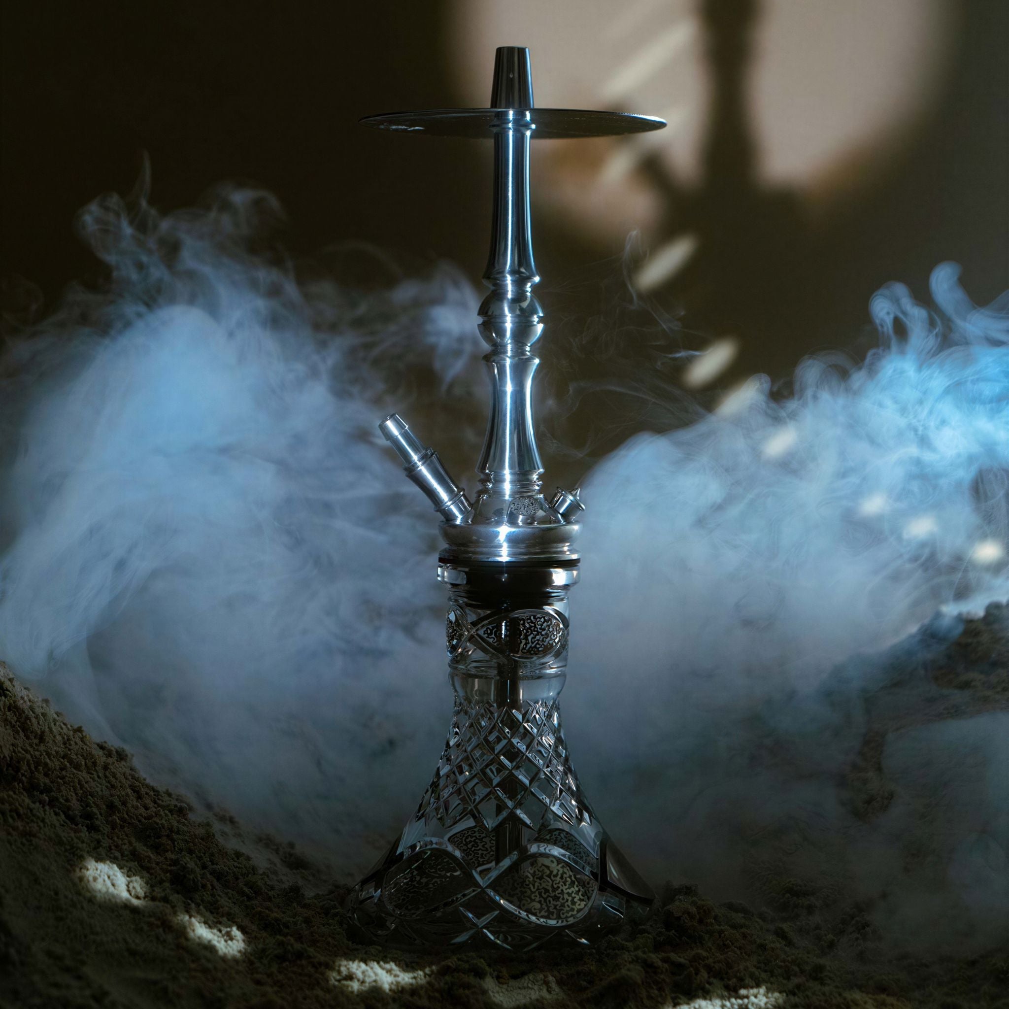 Moze Tradi M Silver traditional shisha in a cool smoky setting with blue haze, polished chrome stem on a cut-glass base