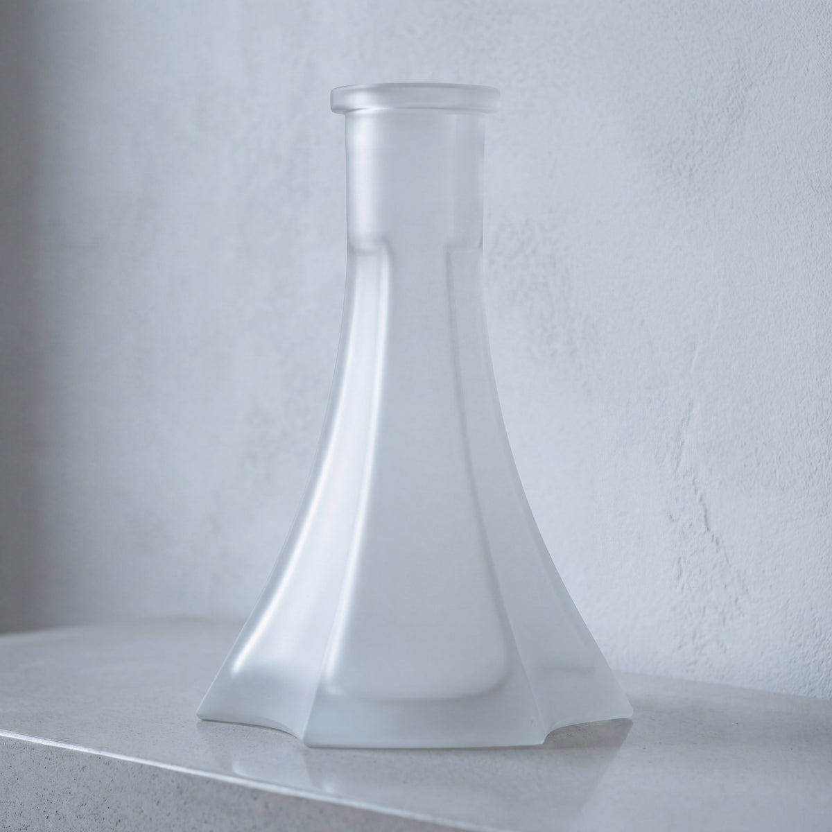 OVO x Neolux Frosty White frosted glass hookah base on pale concrete console in modern interior, image 3 of 5