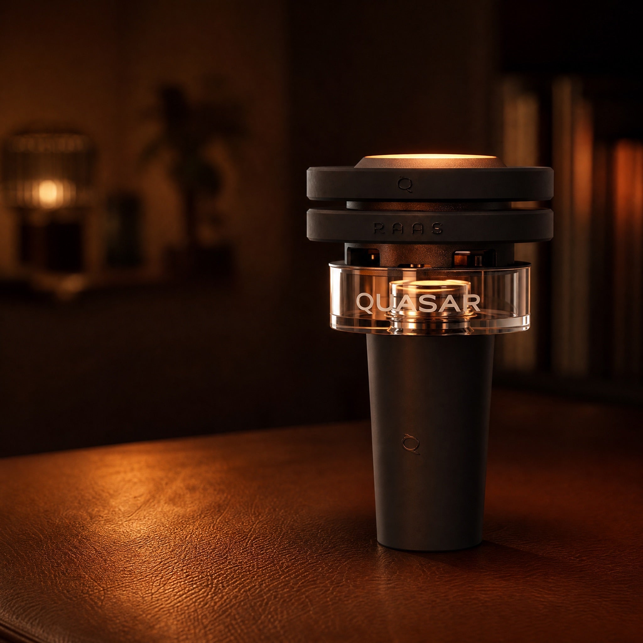 Quasar Petit Raas 2 compact thermal bowl mid-session with a warm single-coal glow on leather