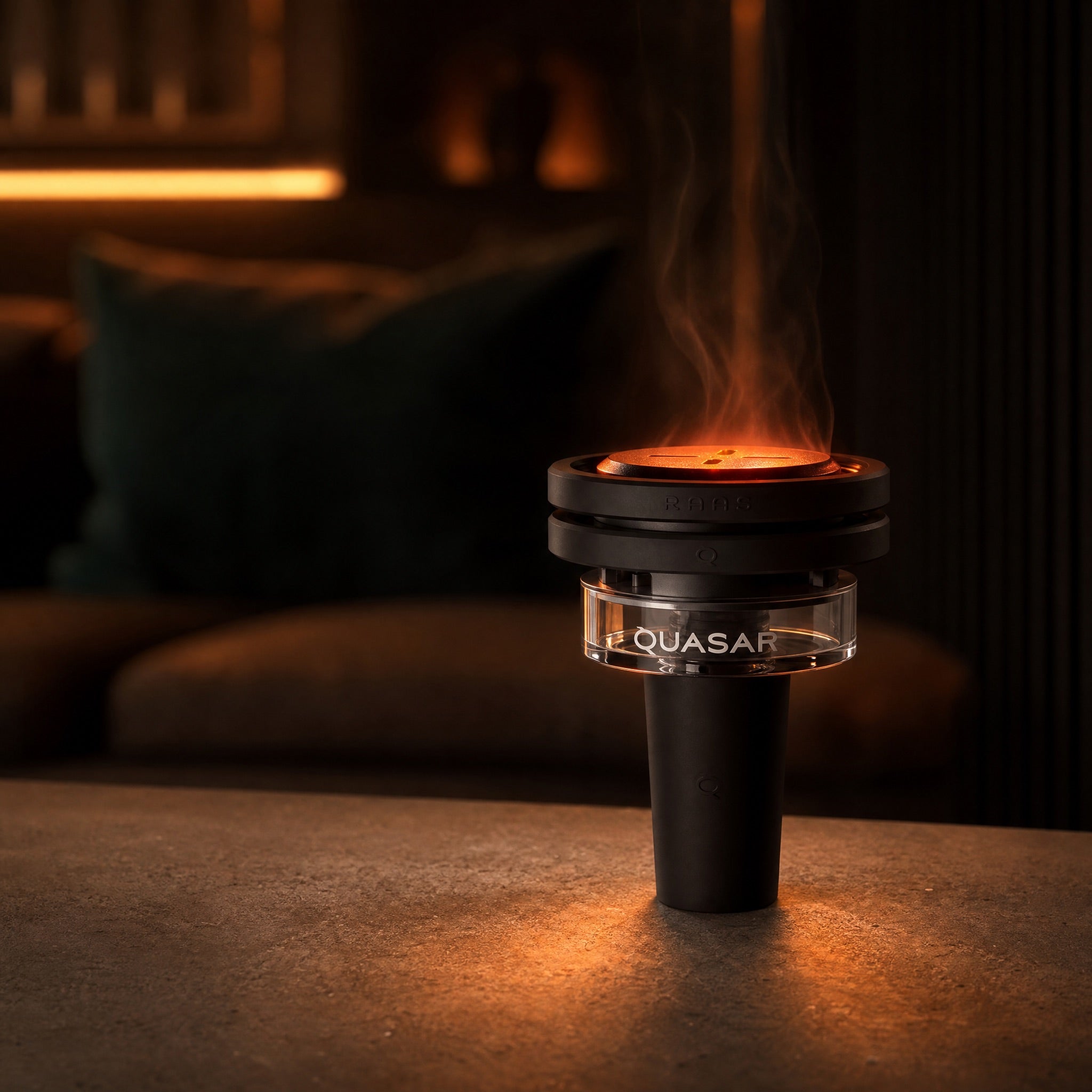 Quasar Raas 2 thermal bowl mid-session with glowing coals on a warm lounge table