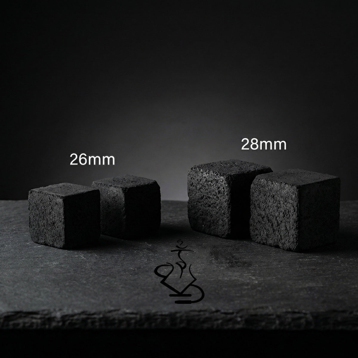 Shaman coconut charcoal size comparison showing smaller 26mm cubes next to larger 28mm XXL cubes on dark slate surface, image 7 of 10