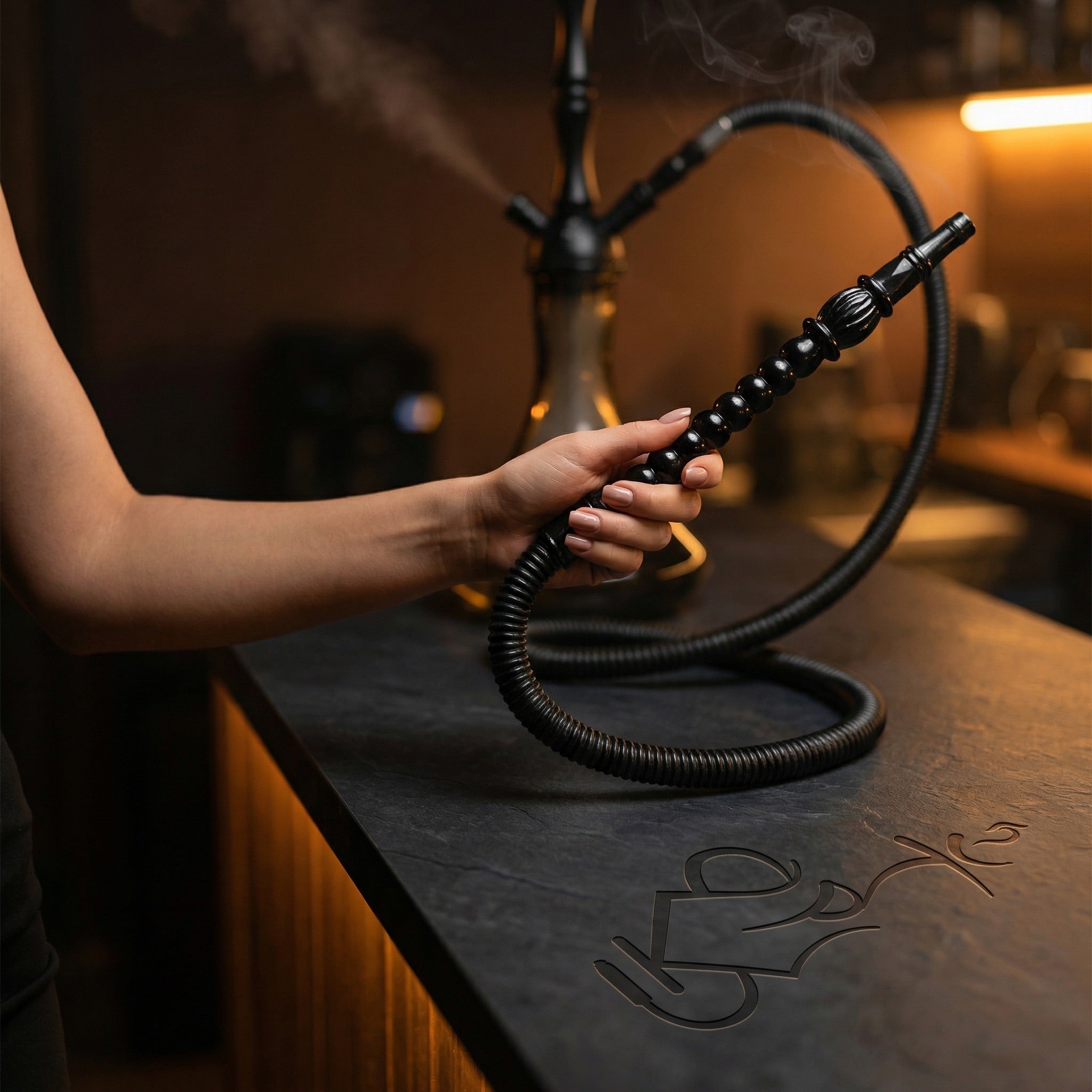 Hand holding ShishaDoc 1.8m disposable hookah hose ornamental handle during a hookah session in a warm lounge setting
