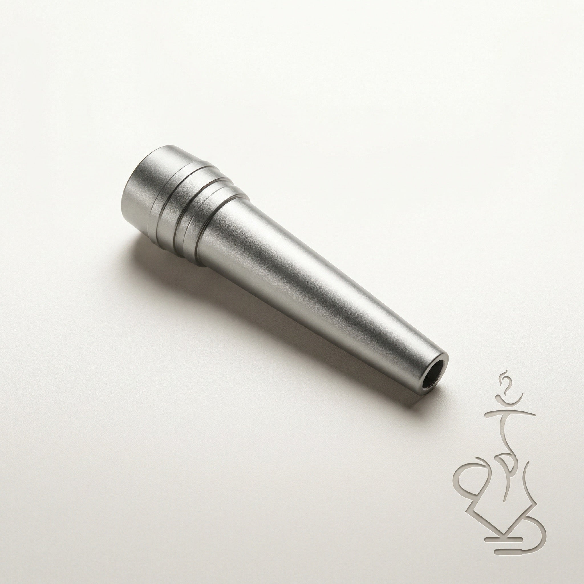 ShishaDoc disposable hookah mouth tip in short matte metallic silver on warm white studio background