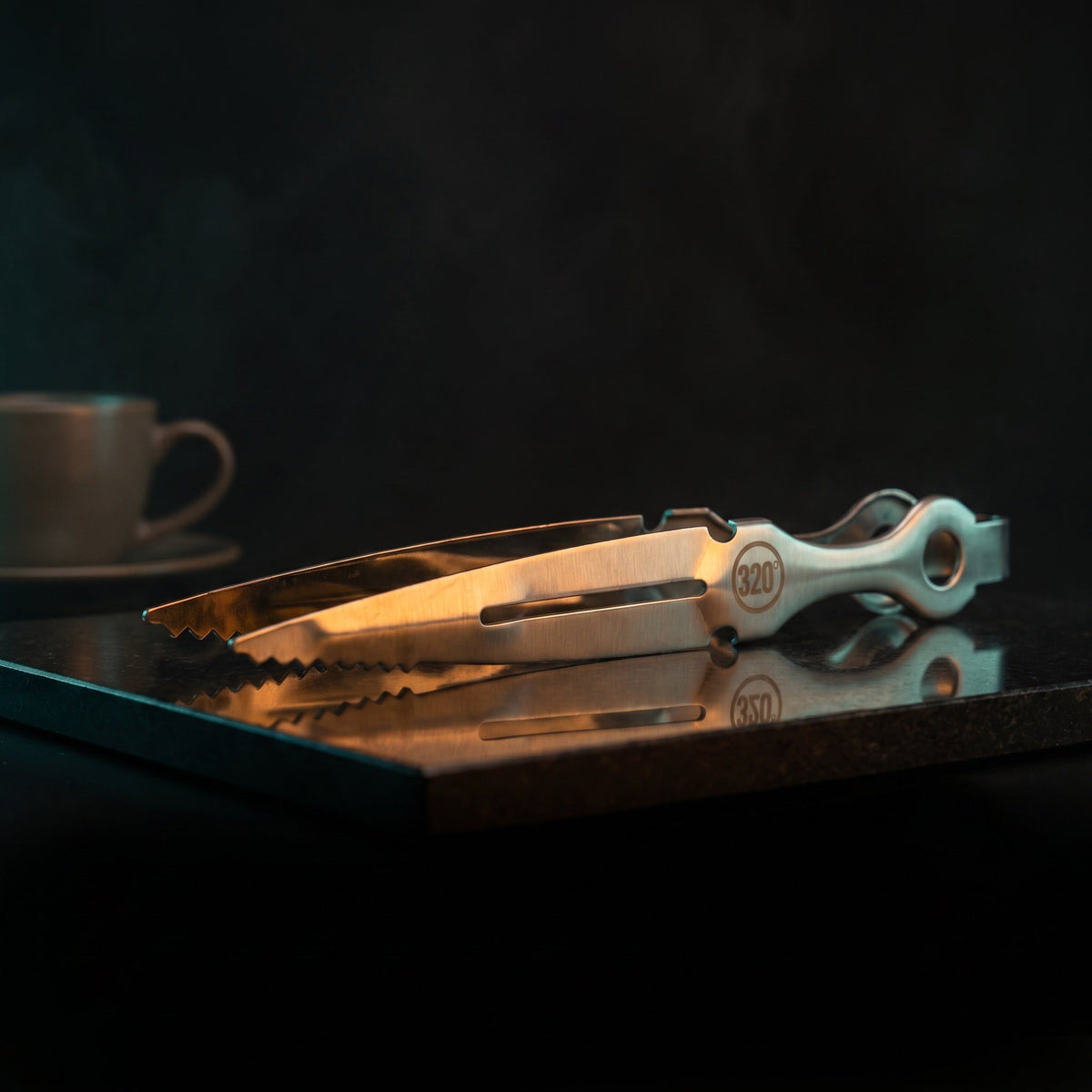 320° silver hookah tongs on polished black stone, atmospheric lounge lighting, image 5 of 9