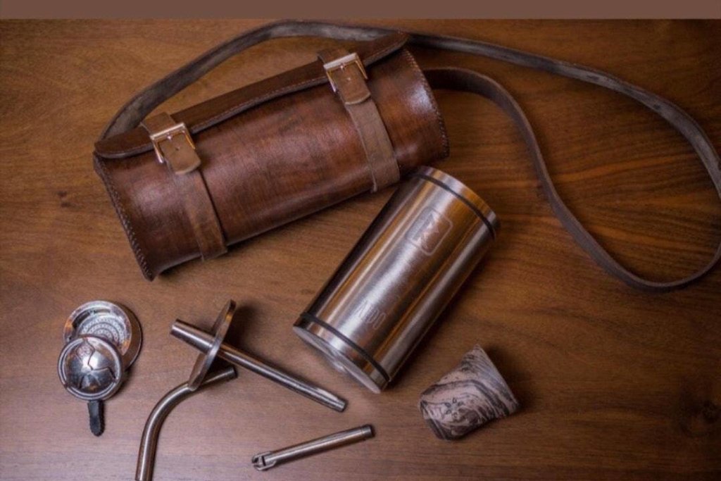 VZ Hookah Raido travel bag in brown leather, a round case with two buckle straps and a shoulder strap, side view, image 3 of 3