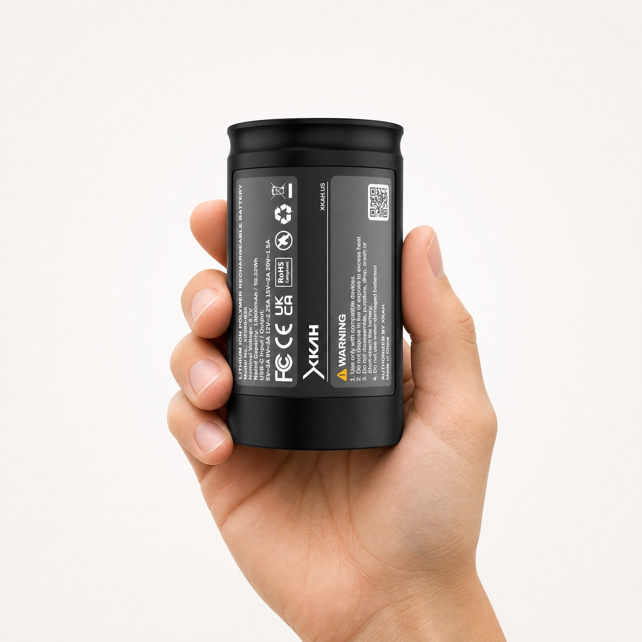 XKAH Pro replacement battery held upright in one hand, swap-ready, showing true size in hand.