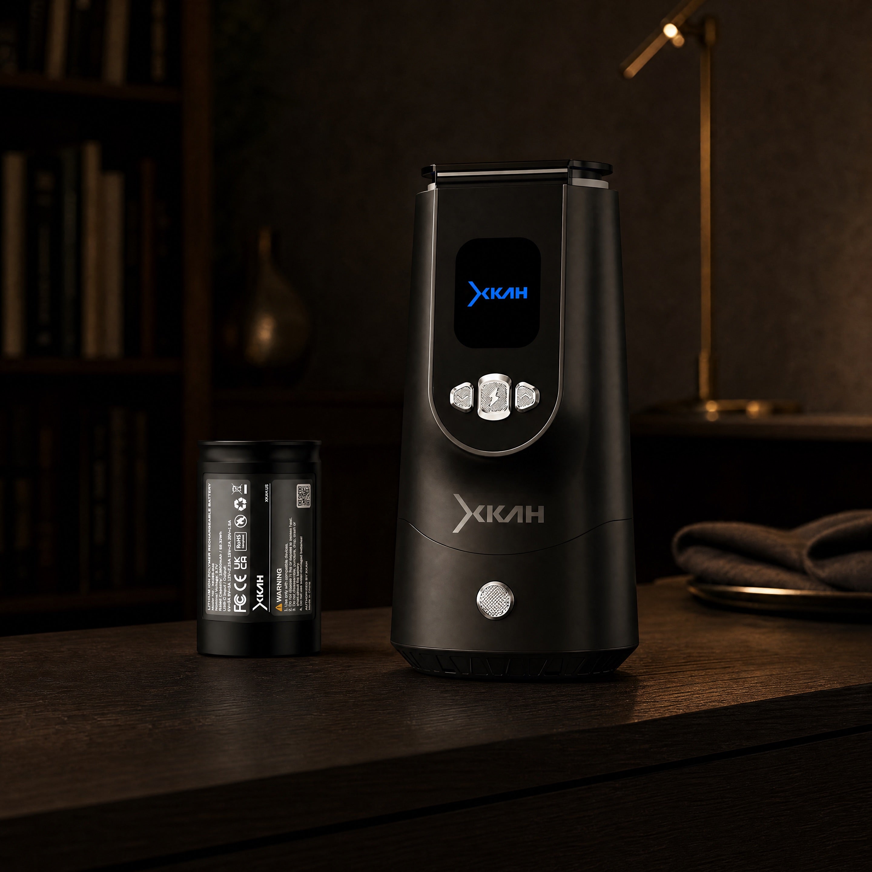 XKAH Pro eHMD and 13,600 mAh battery on a dark walnut study console at dusk with warm lamp light — The Premium Shisha